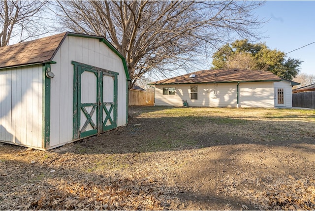 view of shed featuring fence