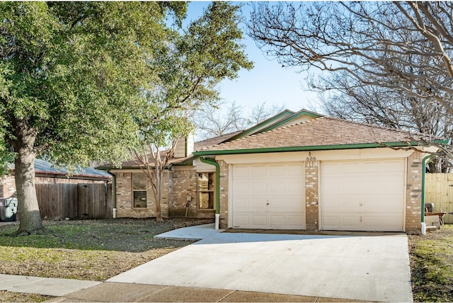 single story home with a garage, brick siding, fence, and roof with shingles