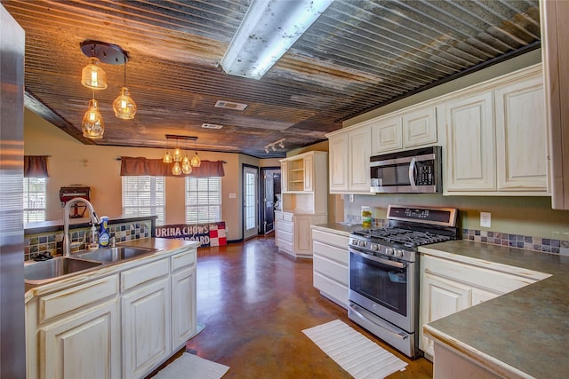 kitchen featuring concrete flooring, a sink, wood ceiling, visible vents, and appliances with stainless steel finishes