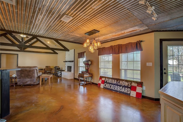 interior space featuring visible vents, a chandelier, concrete flooring, a large fireplace, and wood ceiling