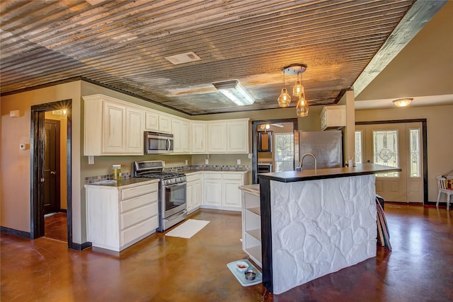 kitchen featuring white cabinets, visible vents, concrete floors, appliances with stainless steel finishes, and hanging light fixtures