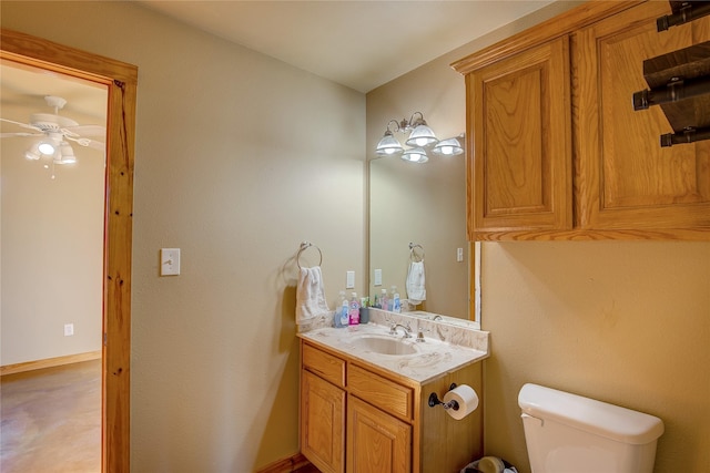 half bath featuring toilet, ceiling fan, and vanity