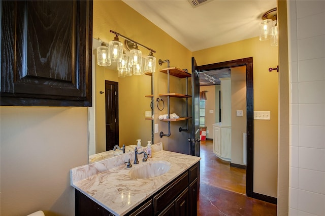 bathroom featuring concrete flooring, visible vents, vanity, and baseboards