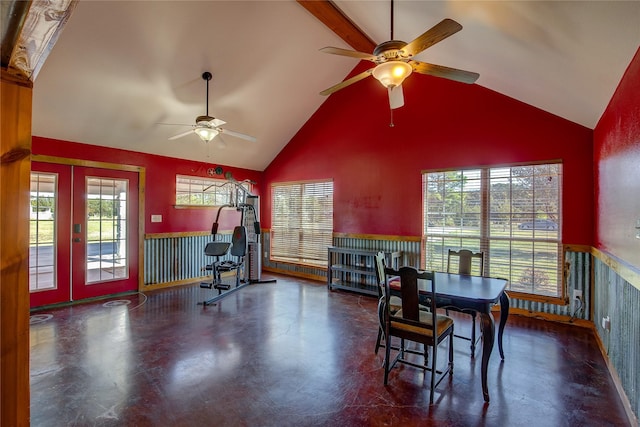 dining room featuring french doors, concrete floors, wainscoting, and a ceiling fan