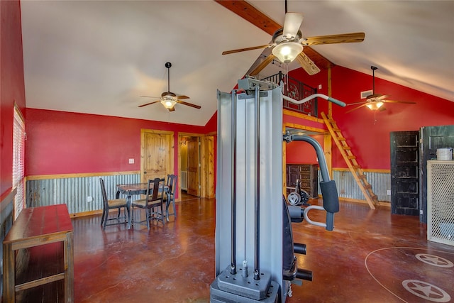 interior space featuring a wainscoted wall, finished concrete floors, and high vaulted ceiling