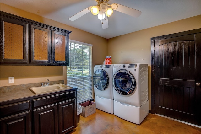 clothes washing area featuring ceiling fan, a sink, cabinet space, and washer and dryer