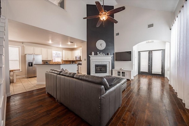 living area with visible vents, dark wood finished floors, and a wealth of natural light