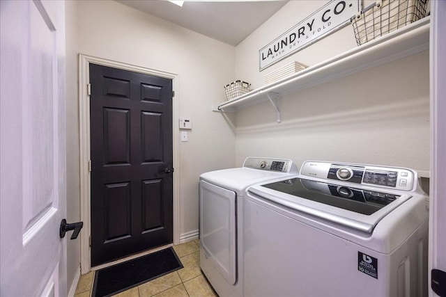 laundry area featuring laundry area, light tile patterned flooring, and washing machine and dryer