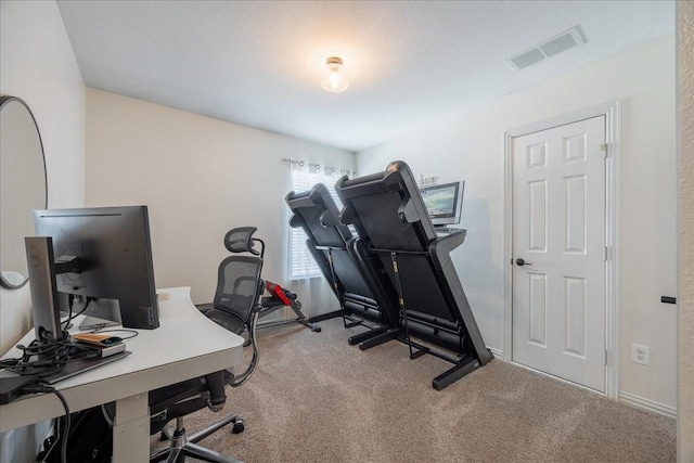 carpeted office with visible vents and baseboards