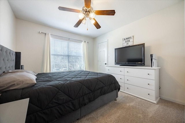 bedroom with baseboards, a ceiling fan, and light colored carpet