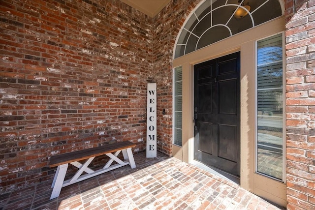 view of exterior entry with a porch