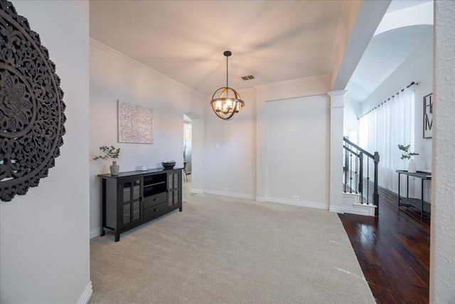 interior space with ornamental molding, visible vents, baseboards, and stairs