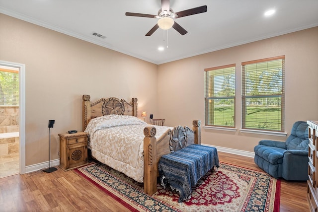 bedroom featuring multiple windows, wood finished floors, visible vents, and crown molding