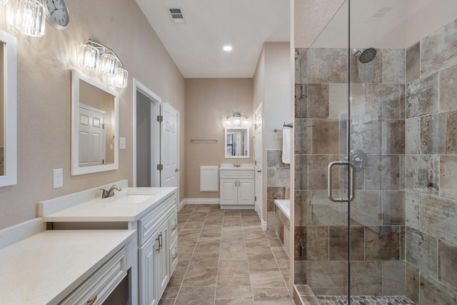 bathroom with visible vents, two vanities, a sink, and a shower stall