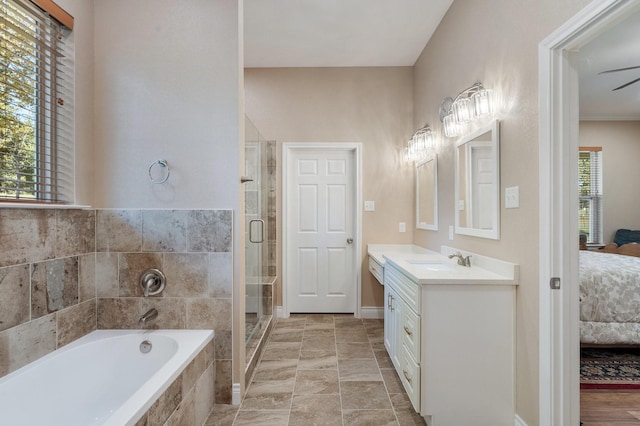 full bathroom featuring a wealth of natural light, connected bathroom, a shower stall, and a bath