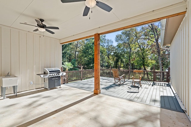 view of patio with ceiling fan, grilling area, and a wooden deck