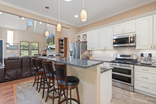 kitchen with open floor plan, stainless steel appliances, a breakfast bar, and backsplash