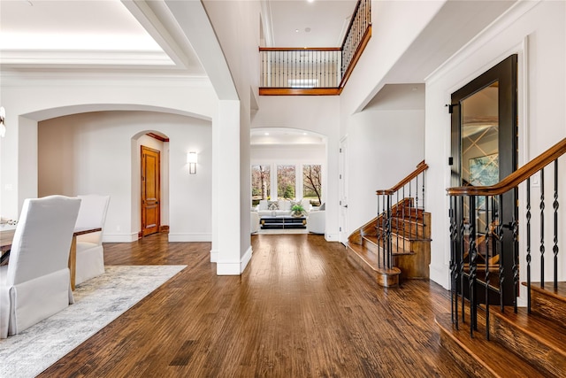 1717 Buckingham Dr, Keller, TX 76262 - entryway with stairs, wood finished floors, baseboards, a towering ceiling, and arched walkways