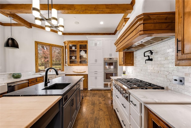 1717 Buckingham Dr, Keller, TX 76262 - kitchen with a sink, appliances with stainless steel finishes, custom range hood, white cabinets, and decorative backsplash