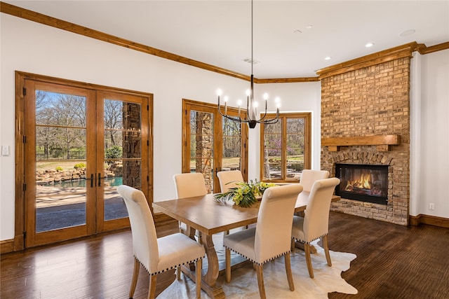 1717 Buckingham Dr, Keller, TX 76262 - dining space with french doors, dark wood finished floors, a chandelier, crown molding, and a fireplace