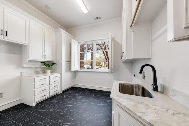 1717 Buckingham Dr, Keller, TX 76262 - kitchen with a sink, white cabinets, dark marble finish flooring, light stone countertops, and crown molding