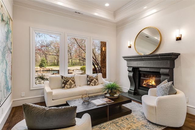 1717 Buckingham Dr, Keller, TX 76262 - living area with wood finished floors, ornamental molding, plenty of natural light, a glass covered fireplace, and baseboards