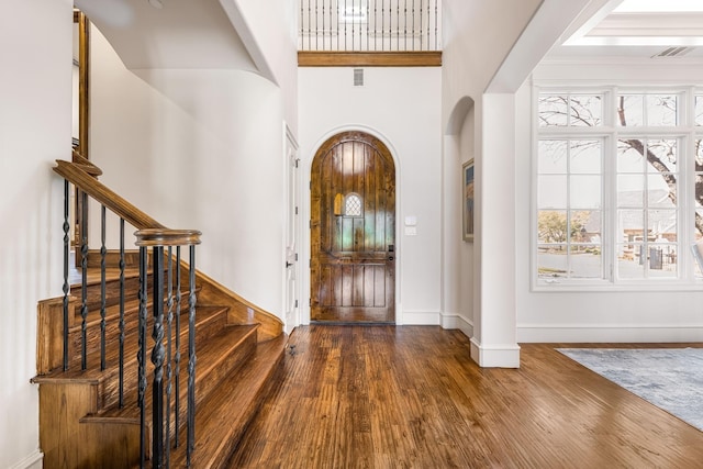 1717 Buckingham Dr, Keller, TX 76262 - foyer featuring arched walkways, wood finished floors, baseboards, and stairs