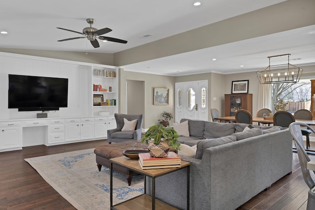 living area featuring recessed lighting, dark wood-style flooring, and crown molding