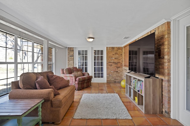 living area with ornamental molding, visible vents, brick wall, and tile patterned floors