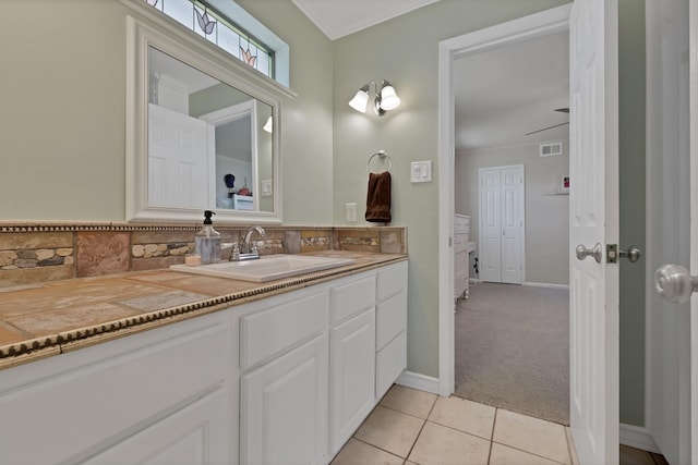 bathroom with visible vents, ornamental molding, tile patterned floors, vanity, and backsplash