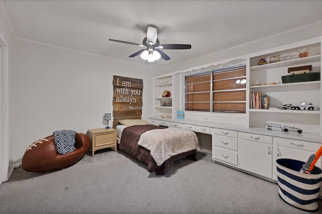 bedroom with light carpet, built in study area, a ceiling fan, and crown molding