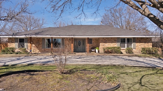 ranch-style house with brick siding and roof with shingles