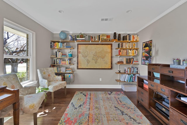 sitting room with dark wood-type flooring, a healthy amount of sunlight, visible vents, and crown molding