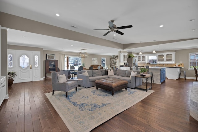 living room featuring a healthy amount of sunlight, visible vents, dark wood-style flooring, and recessed lighting