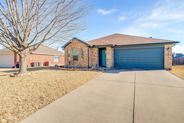 ranch-style house with driveway, brick siding, roof with shingles, and an attached garage