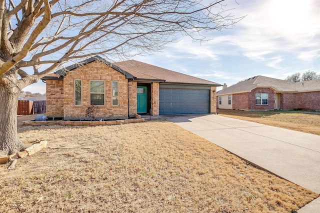 single story home with brick siding, concrete driveway, an attached garage, fence, and a front yard