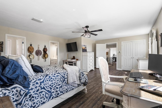 bedroom with dark wood-style flooring, a closet, visible vents, connected bathroom, and ceiling fan