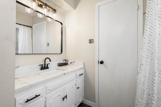 full bathroom featuring vanity and baseboards