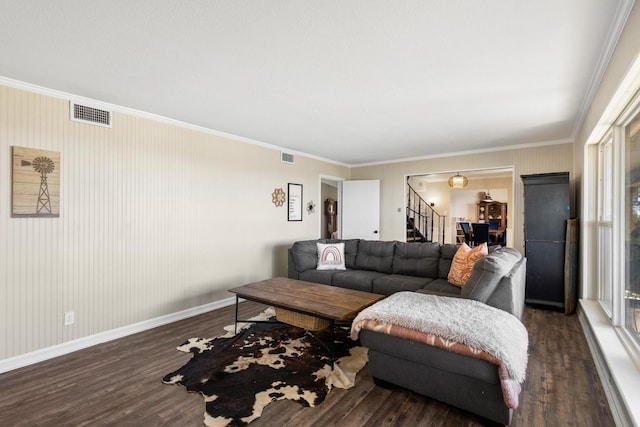 living area with baseboards, visible vents, stairway, wood finished floors, and crown molding