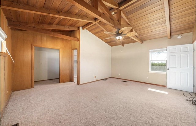 unfurnished bedroom with vaulted ceiling with beams, wooden ceiling, carpet, and baseboards