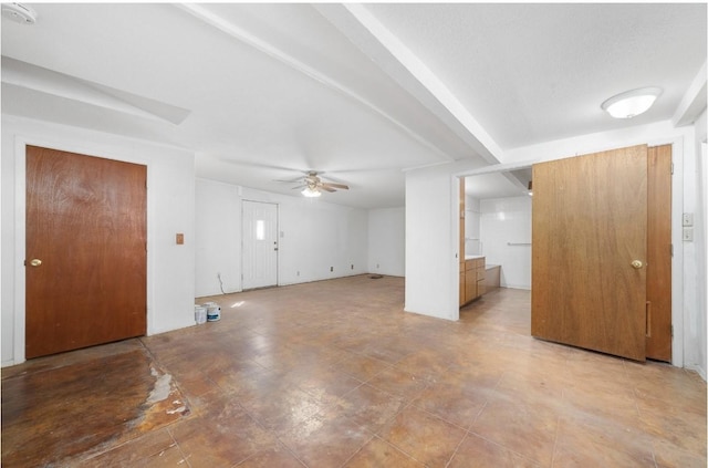 interior space featuring ceiling fan and beamed ceiling