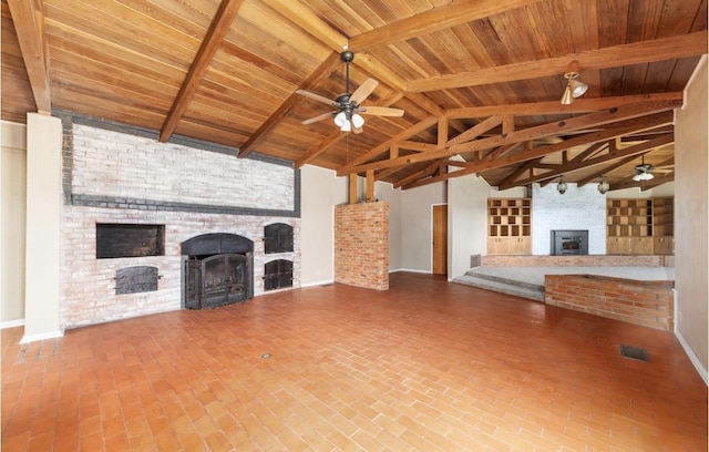 unfurnished living room featuring a large fireplace, wood ceiling, lofted ceiling with beams, and a ceiling fan