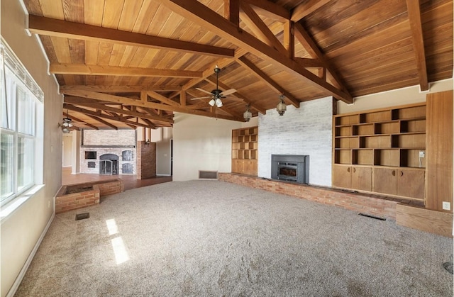 unfurnished living room featuring carpet floors, a large fireplace, and visible vents