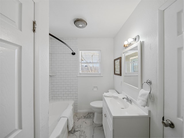 full bathroom with marble finish floor, toilet, vanity,  shower combination, and baseboards