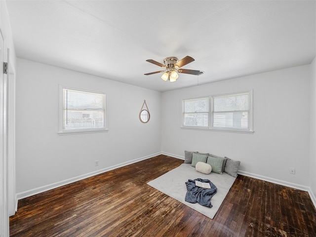 unfurnished room with wood-type flooring, a wealth of natural light, and baseboards