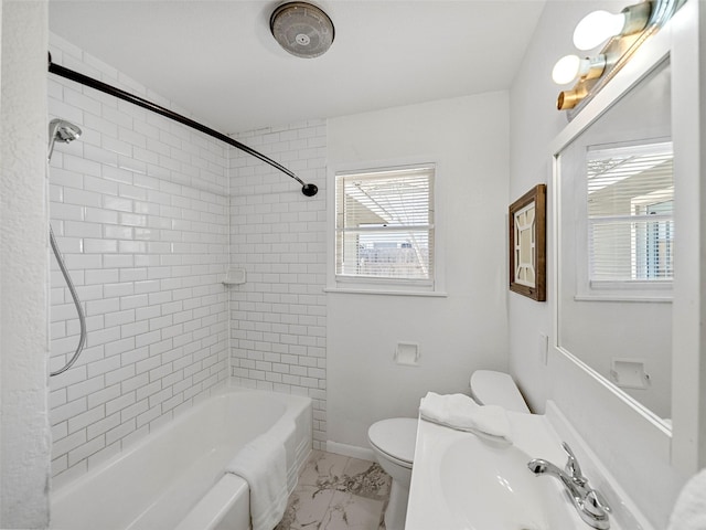 full bath featuring marble finish floor, bathtub / shower combination, toilet, a sink, and baseboards