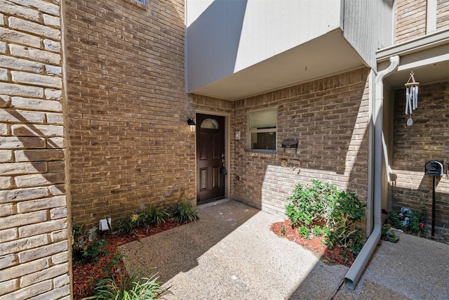 property entrance with brick siding