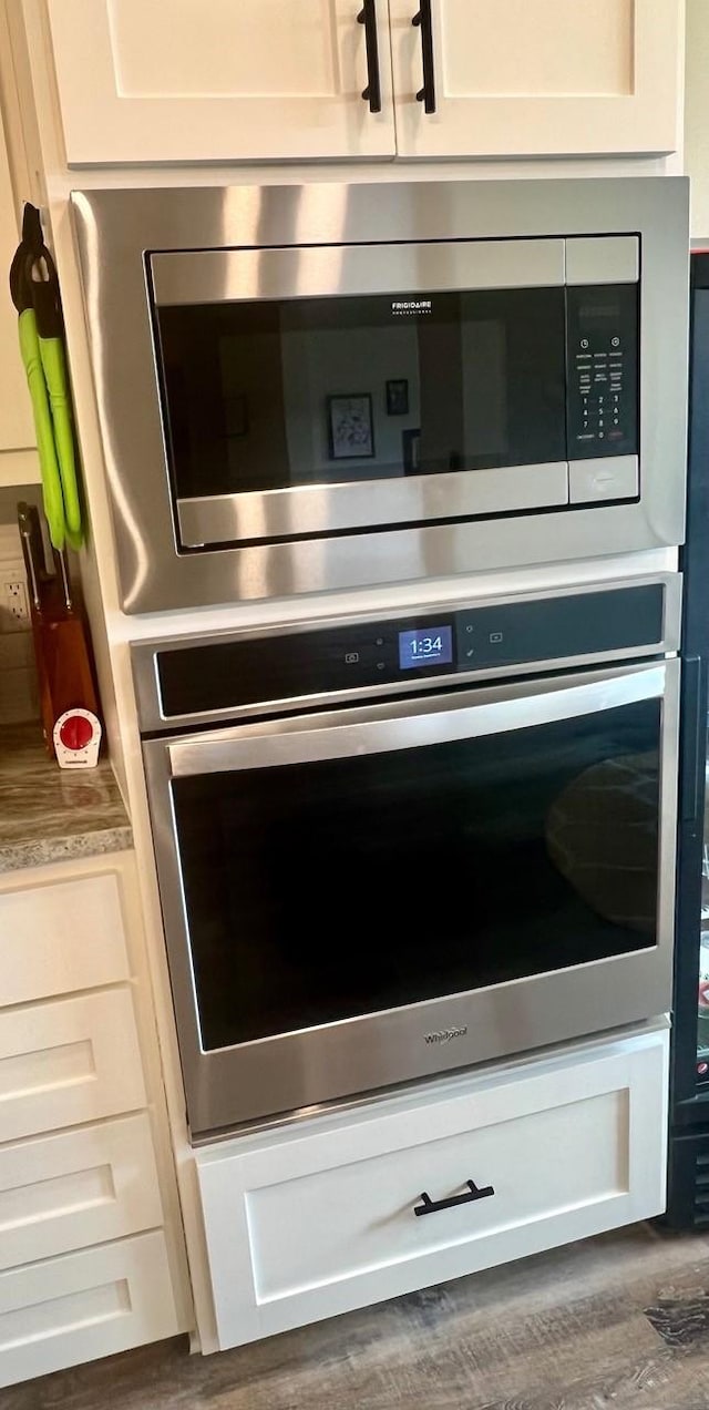 details featuring appliances with stainless steel finishes and light countertops