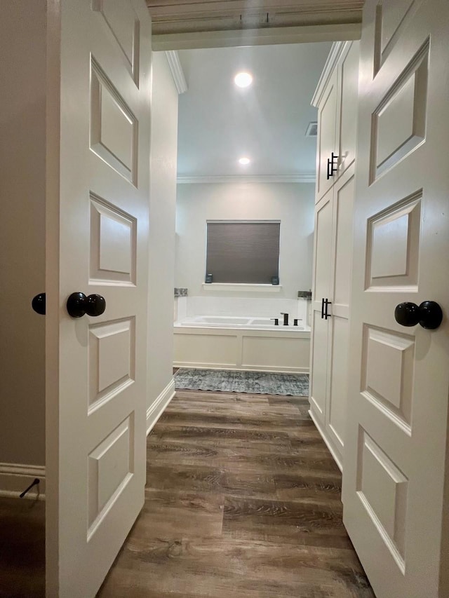 full bathroom with a garden tub, crown molding, recessed lighting, visible vents, and wood finished floors