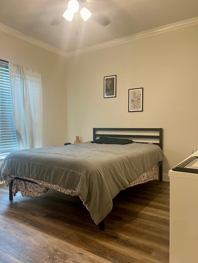 bedroom with ceiling fan, crown molding, and wood finished floors